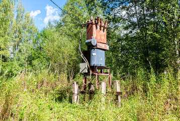 Old voltage power transformer substation at the countryside