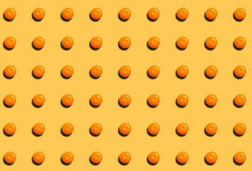New Year's pattern with whole ripe tangerines on an orange background. Citrus diet template.