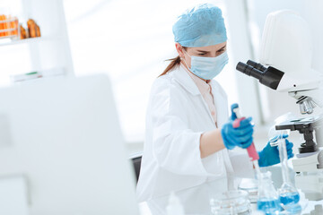 female scientist conducts research in the laboratory.