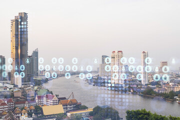 Social media icons hologram over panorama city view of Bangkok, Southeast Asia. The concept of people networking, connections and career opportunities. Double exposure.
