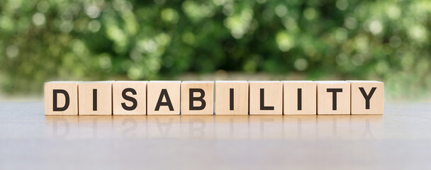 disability text on light cubes on a green background