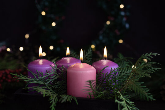 Three purple and one pink advent candles in Christmas eve. - Powered by Adobe