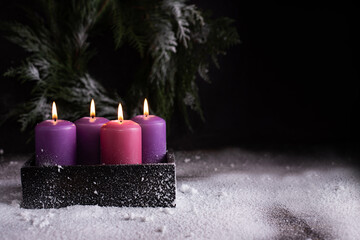 Christmas eve, one pink and three purple advent candles.