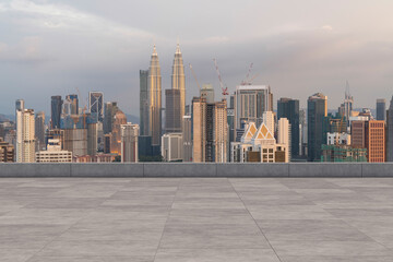 Panoramic Kuala Lumpur skyline view, concrete observatory deck on rooftop, sunset. Asian corporate...