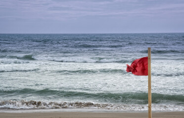 Red warning flag on Mediterranean beach - 471896857