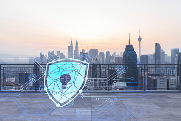 Rooftop with concrete terrace, Kuala Lumpur sunset skyline. Cyber security concept to protect clients confidential information. IT hologram padlock icons. City downtown. Double exposure.