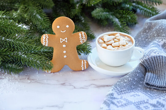 Coffee Cup With Marshmallows, Gingerbread Man Cookie, Sweater, Fir Tree Branches On Table. Christmas And New Year Holidays Concept. Festive Winter Season.