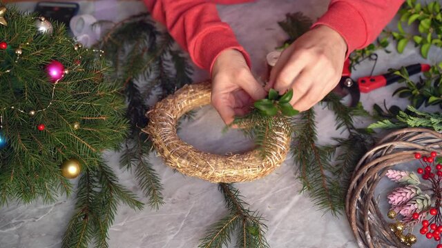 Making rustic christmas wreath. Start making a Christmas wreath based on hay. Close-up. Making crafts. Seasonal holiday workshop online, making festive decorations at home. Selected focus