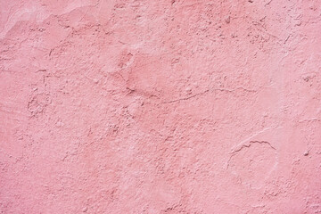 Concrete pink background with cracks, scuffs and splashes. Wall texture, delicate color