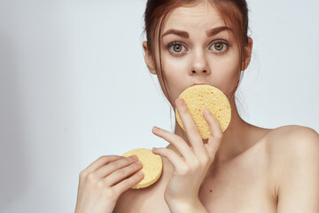 woman yellow sponge clean skin hygiene light background