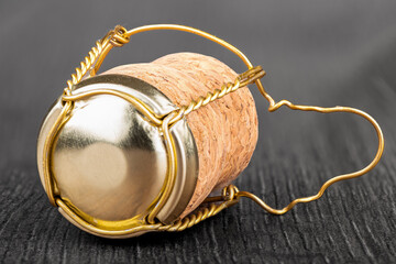 Close-up on a champagne cork with a Muselet on a colorless background.