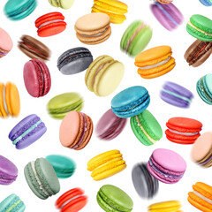 Colored macaroons with different flavors in chaotic motion on a white background