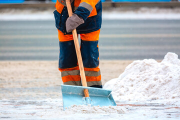 Communal services worker removes snow from road in winter, Cleaning city streets and roads during snowstorm. Moscow, Russia.