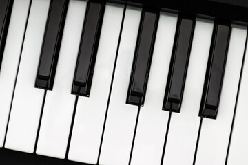 Black and white electronic piano keys. Top view of a fragment of a musical instrument