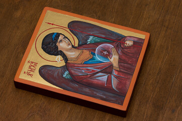 Hand painted orthodox icon during painting on piece of wood. Letters ΑΡΧ ΜΙΧΑИΛЪ means Archangels Michael.
