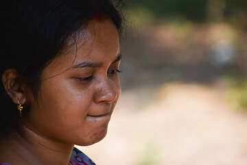 Indian woman at home deep in thoughts, thinking and planning her day. facial expression concept with selective focus.