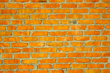 Red brick wall with gray cement glue joint. Creative vintage background.