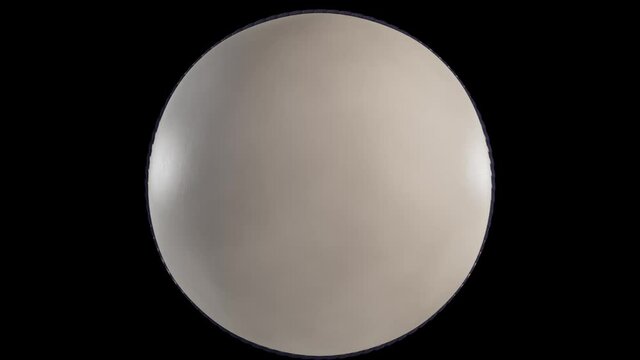 A 4K loop able animation of a white cricket ball spinning in slow motion on dark background with alpha included