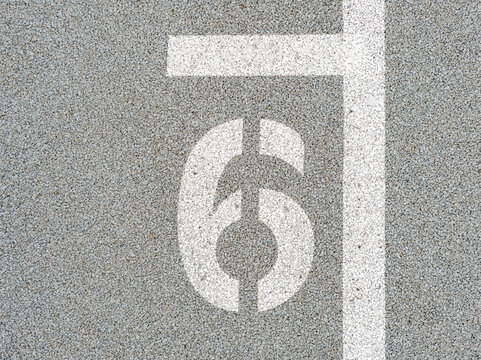 Number six painted on soft rubber surface. The sixth. Hopscotch game