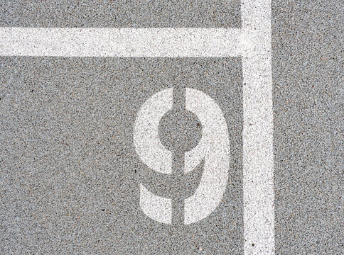 Number nine painted on soft rubber surface. The nineth place