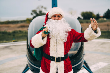 Happy Santa Claus arrives via helicopter to deliver presents to children.
