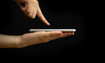 Naklejka premium Mobile phone and index finger isolated, palm up, product demonstration concept. Copy space, template photo