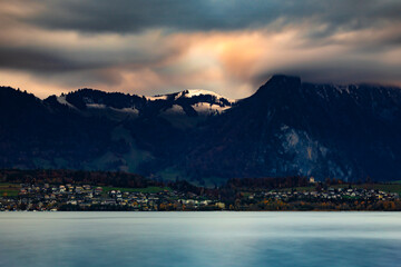 Clouds over the snow-capped mountains on Lake Thun