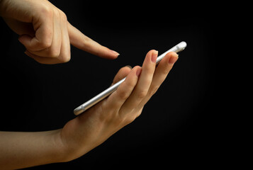 Mobile phone and index finger isolated, palm up, product demonstration concept. Copy space,...
