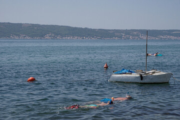People relaxing and snorkeling in the ocean in Croatia 