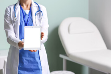 Female doctor with tablet computer in medical office