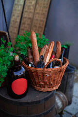 vintage wine bottle and basket with bread still life of restaurant patio outdoor space marketing object, vertical photo