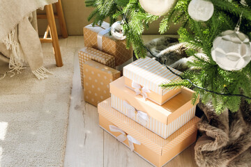 Stack of gift boxes on floor under Christmas tree