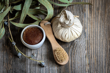 Spa composition with body care products on a wooden background.