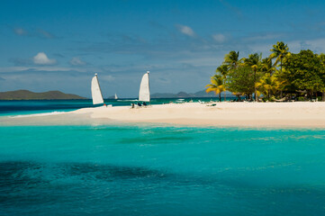 View over beautiful bay to palms and beach of Palm Island. White sand, turquoise sea, boats on...
