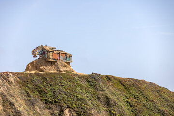 Old vandalized and weathered bunker set on a hill in California