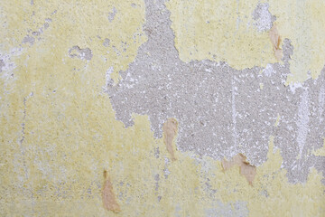 Yellow and Gray Dirty Plaster Wall, With Falling Off Flakes Of Paint. Rough Surface. Peeled Plaster. High quality photo