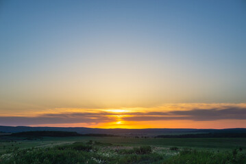 The sunset is far on the horizon. Summer.