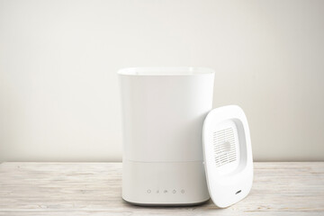 Modern humidifier, on a wooden table.