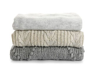 Stack of trendy grey sweaters on white background