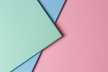 Abstract creative geometric pastel pink, light green and blue paper background with copy space