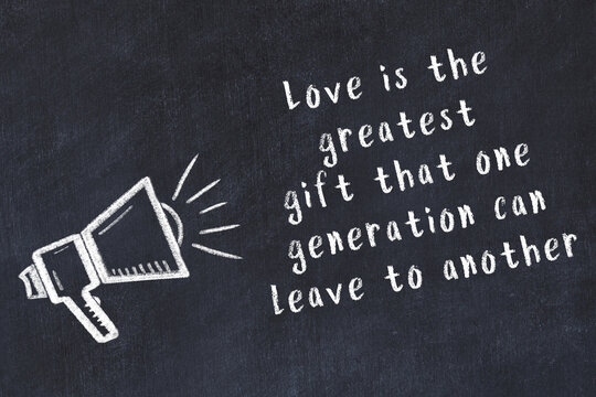 Chalk sketch of loudspeaker on black desk and movitational quote