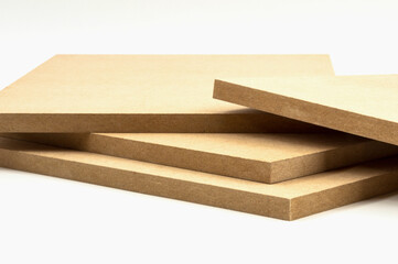 Four MDF boards, of identical dimensions, stand in no order, on a white surface.