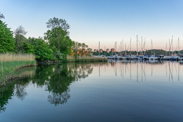 A bay on the island in the center of Stockholm before the sunset with typically sailboats and nature