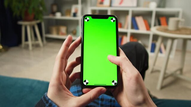 Woman using phone with chroma green screen, vaccination passport with qr code, international coronavirus covid 19 vaccine certificate on mobile device, green zone. High quality 4k footage