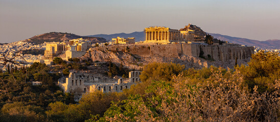 The Acropolis of Athens, Greece, with the Parthenon Temple atop the hill during sunset. © Juan