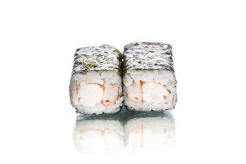 Two pieces of Japanese Ebi Maki sushi roll with nori seaweed on top. Shrimp inside roll. Side view of inside out roll isolated on white background. Copy space menu image with reflection 

