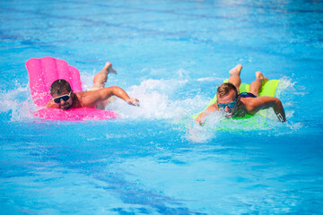 Two men bathe in the pool and relax