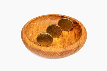 Small money (coins of 10 rubles). Russian money in a plate. Alms, poverty, begging.