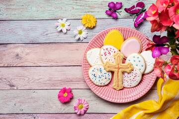 Easter cookies in a plate on pastel background captured from above. Spring holidays. Pink colors