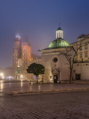 Fototapeta na wymiar Main market square and St Mary's church in the fog night, Krakow, Poland